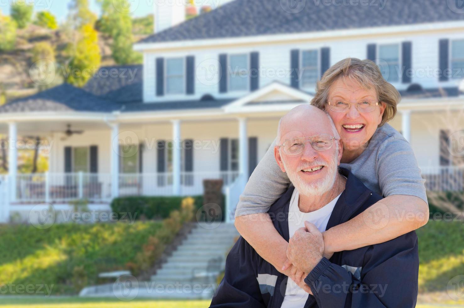 Happy Senior Couple in Front of House photo