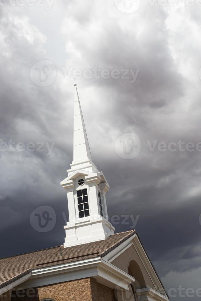 torre del campanario de la iglesia debajo de ominosas nubes tormentosas de tormenta. foto