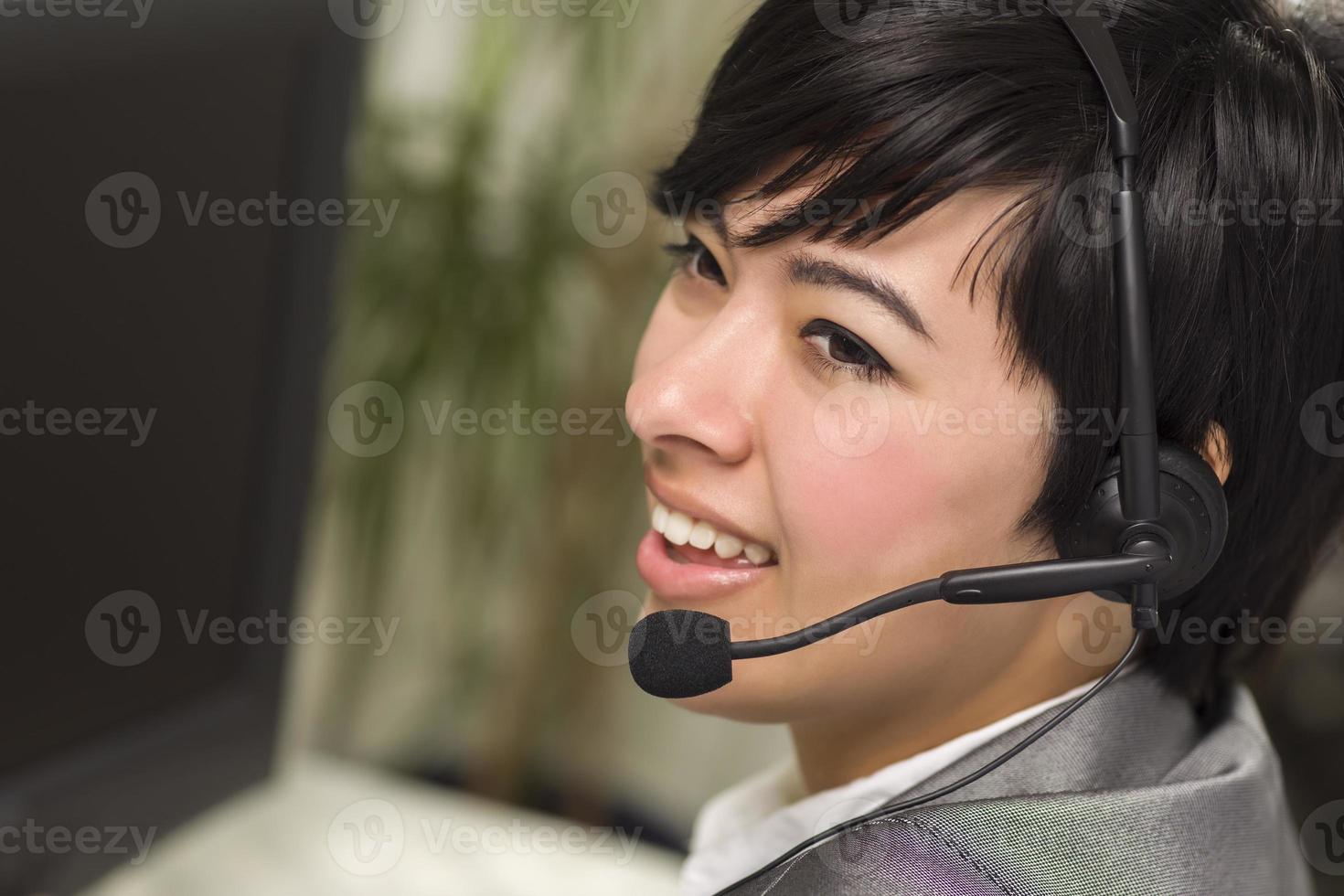 Attractive Young Mixed Race Woman Smiles Wearing Headset photo