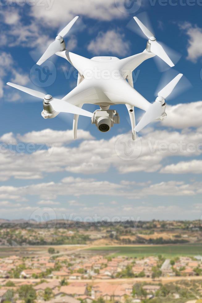 Unmanned Aircraft System Quadcopter Drone In The Air Over Rural Neighborhood Houses. photo