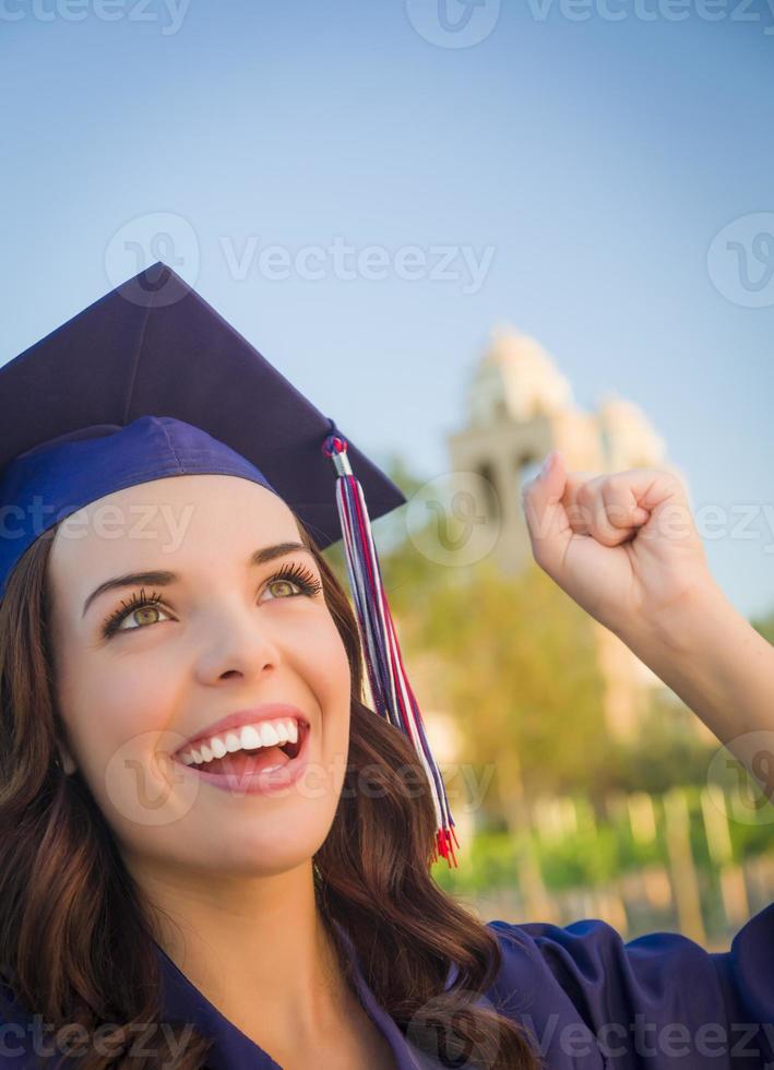 Happy Graduating Mixed Race Woman In Cap and Gown photo