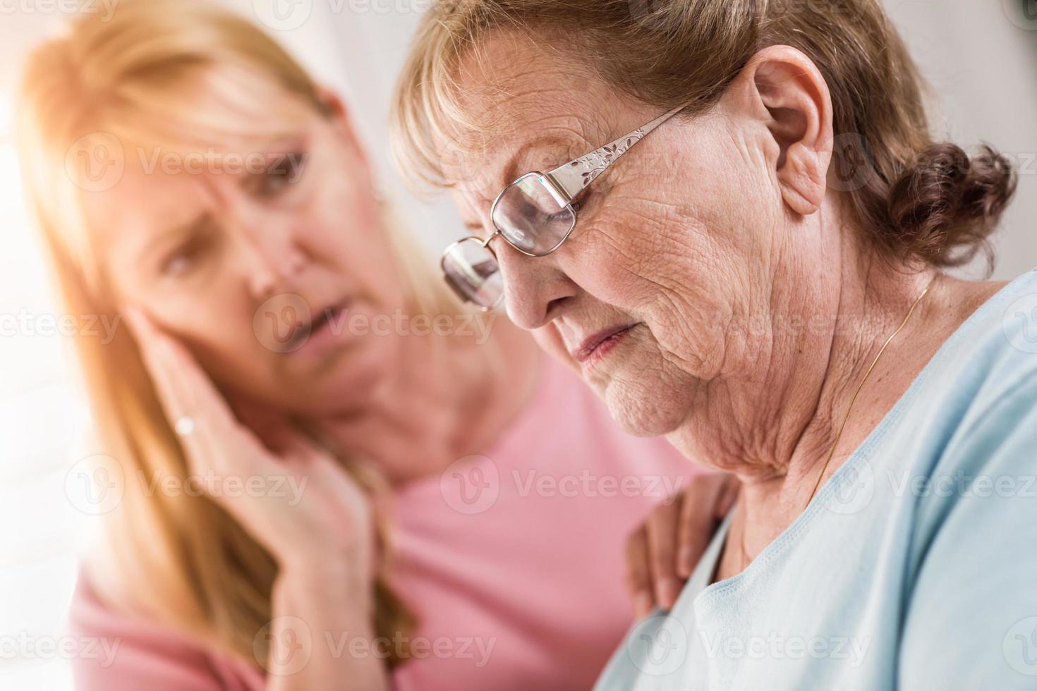 Young Adult Woman Consoles Sad Senior Adult Female photo