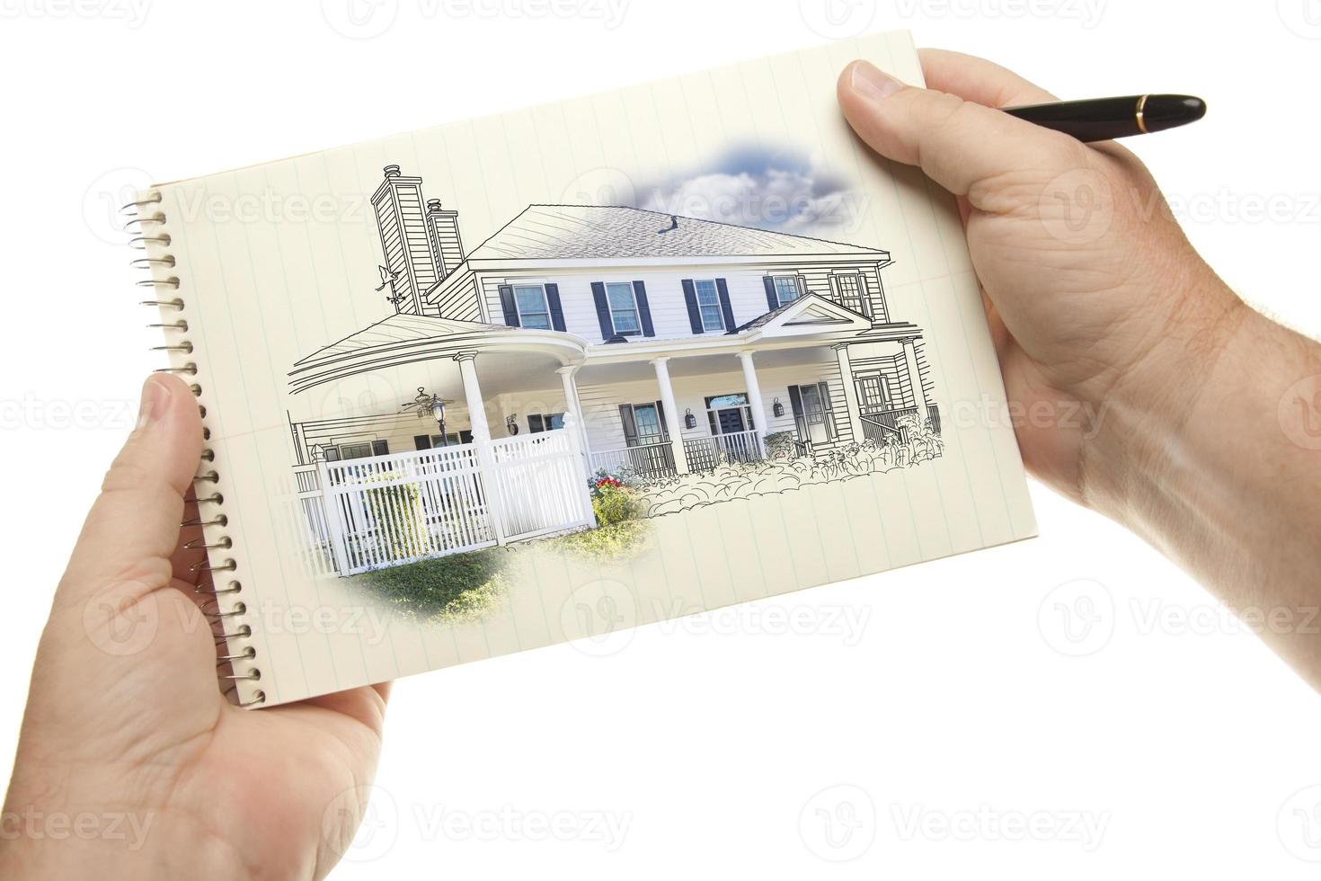 Hands Holding Pen and Pad of Paper with House Drawing photo