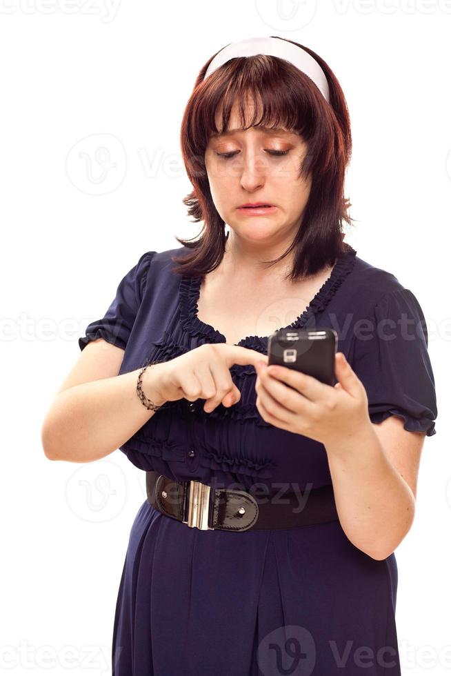 Reluctant Young Caucasian Woman Texting On Mobile Phone photo