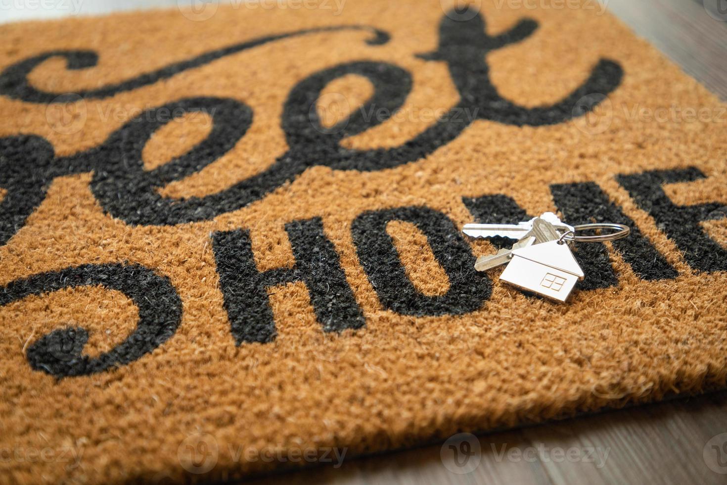 New House Keys and Keychain Rests on Home Sweet Home Welcome Mat photo