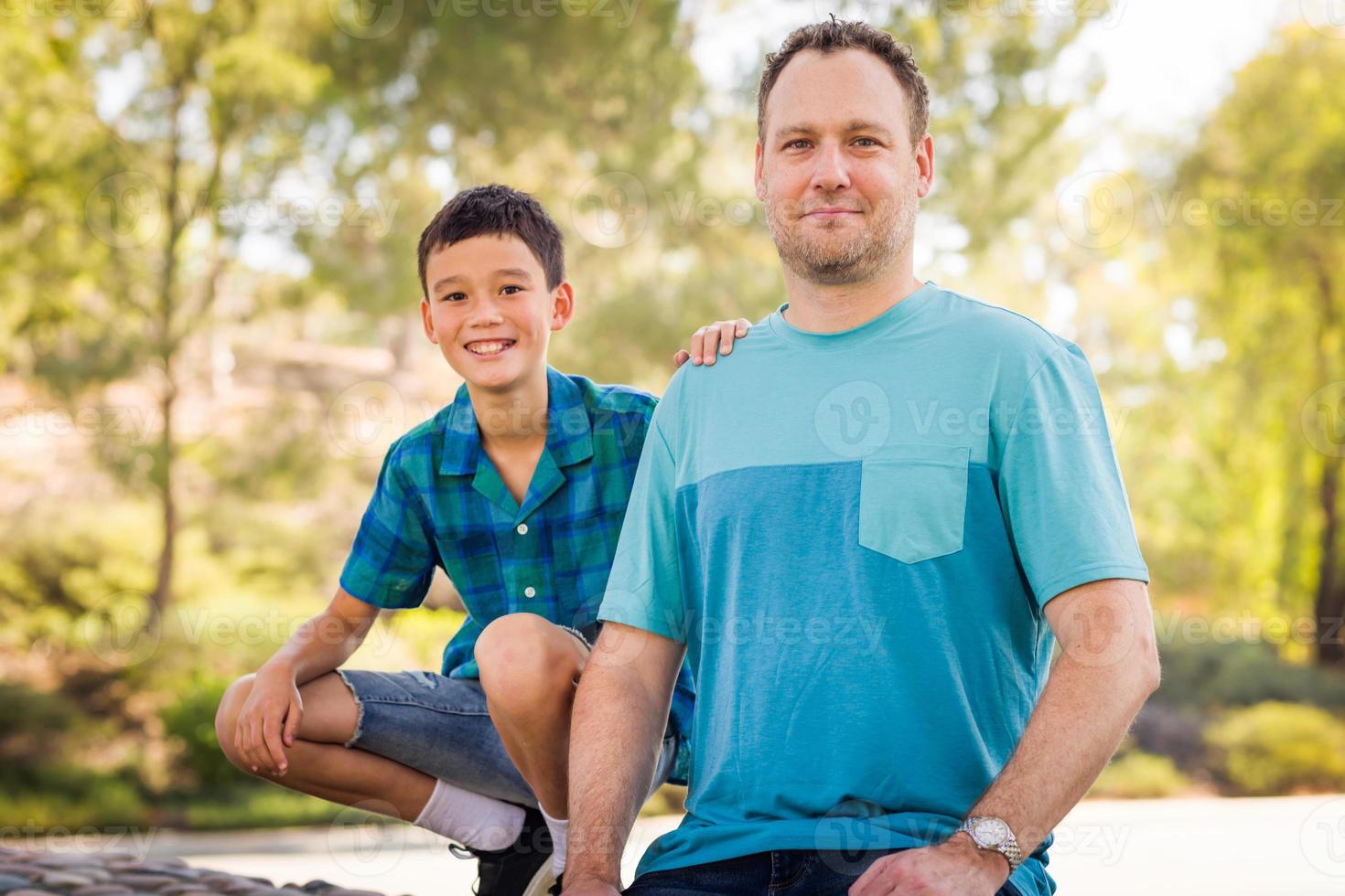 Outdoor portrait of biracial Chinese and Caucasian father and son. photo