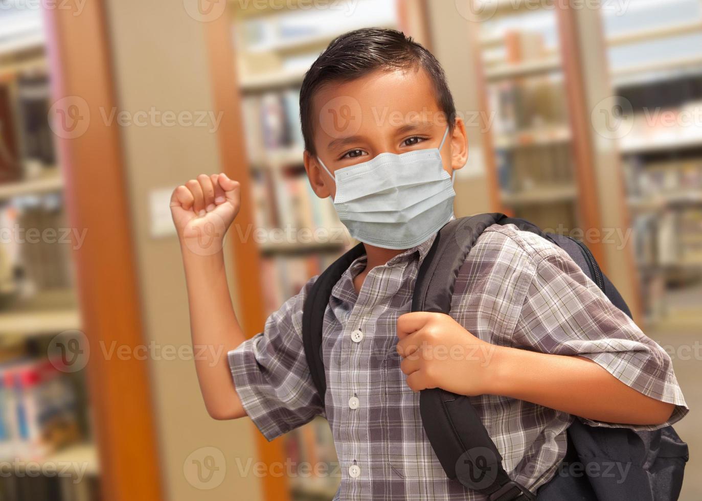 Hispanic Student Boy Wearing Face Mask with Backpack in the Library photo