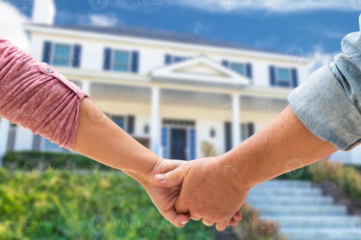 Couple holding hands. New home owners photo
