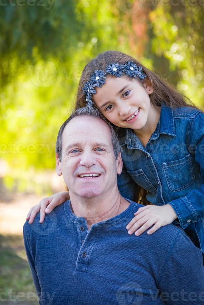 Cute Young Mixed Race Girl And Caucasian Grandfather Having Fun Outdoors photo