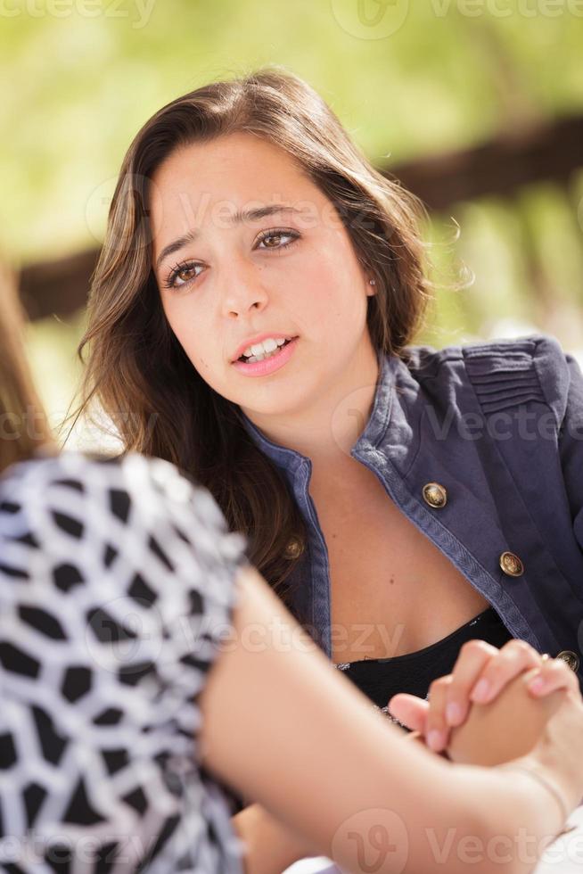 Concerned Young Adult Woman Talking With Her Friend photo