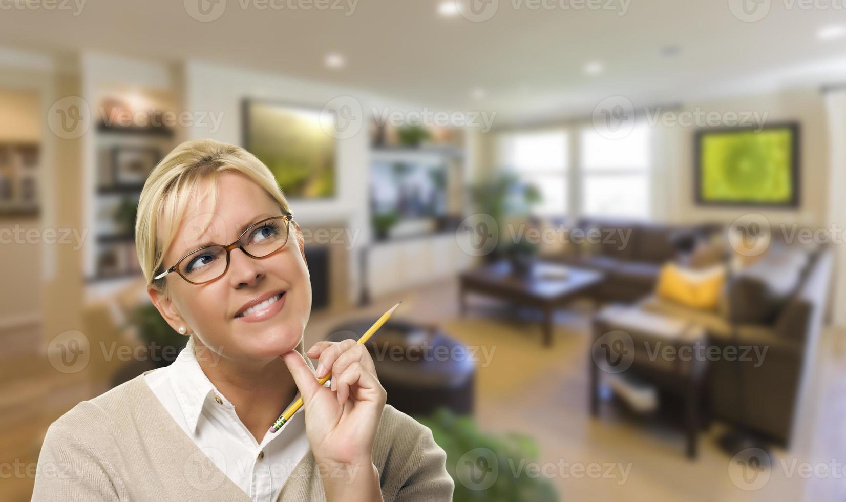 Daydreaming Woman with Pencil Inside Beautiful Living Room photo