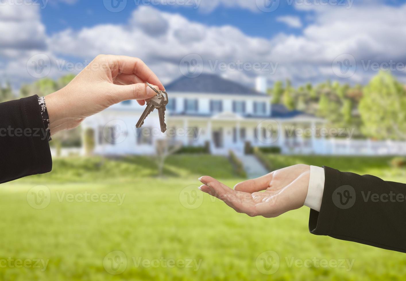 Agent Handing Over House Keys in Front of New Home photo