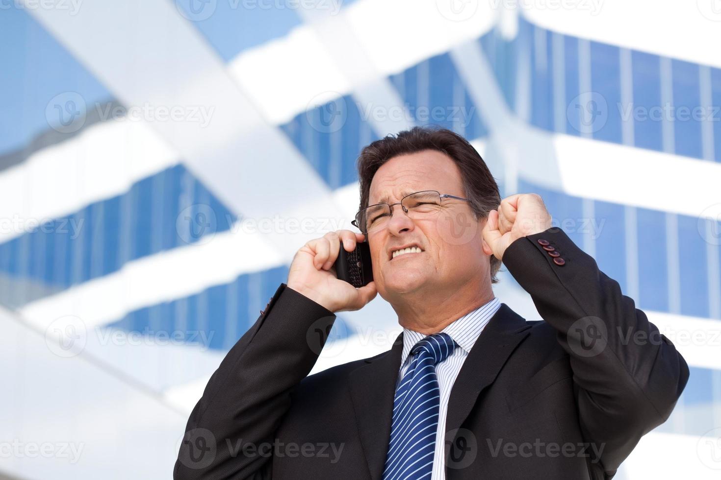 Excited Businessman on Cell Phone photo