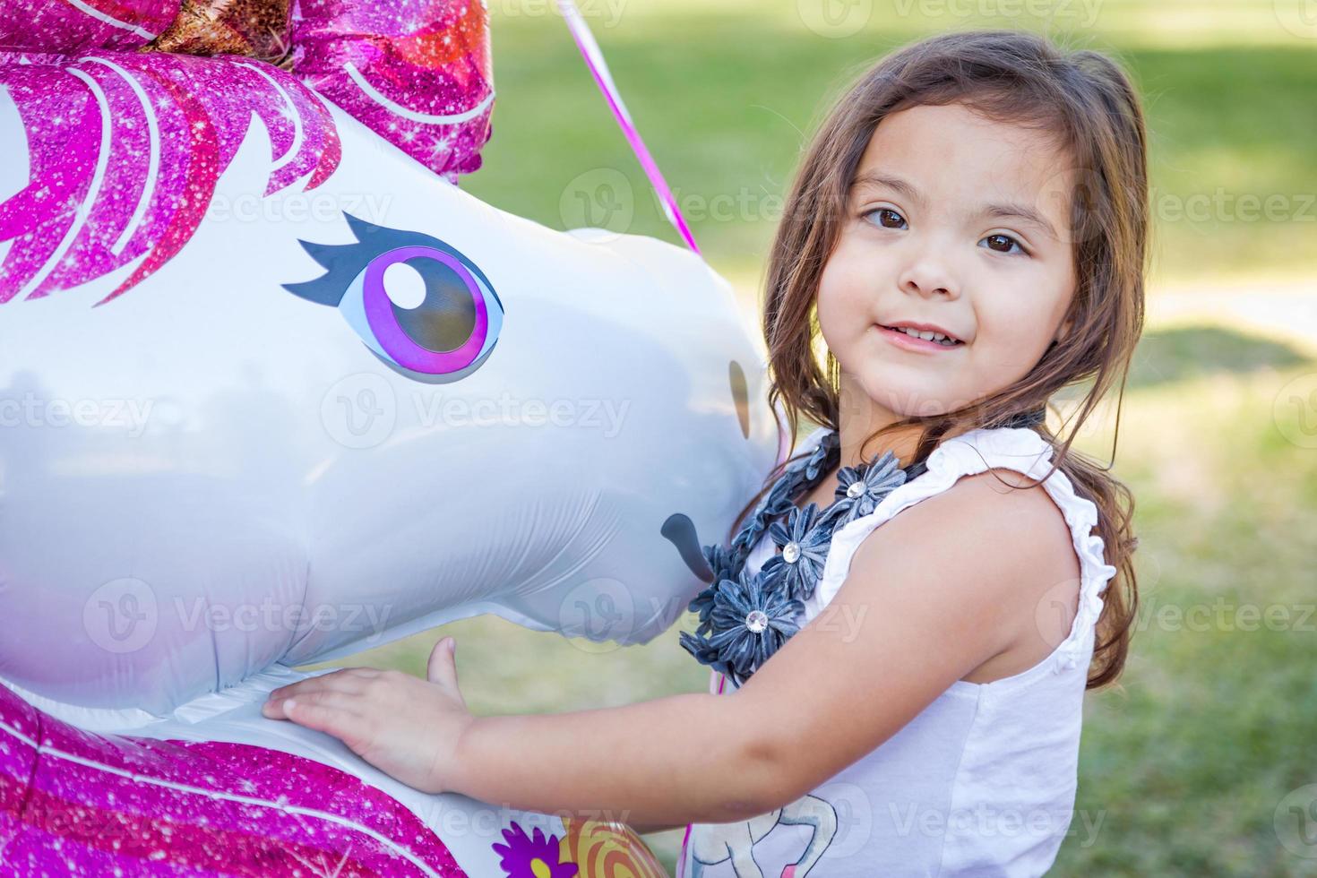 Cute Young Mixed Race Baby Girl Holding Mylar Balloon Outdoors photo