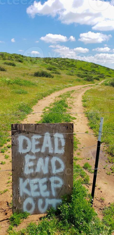 Dead End Keep Out Sign On Wire Fence At Dirt Road photo