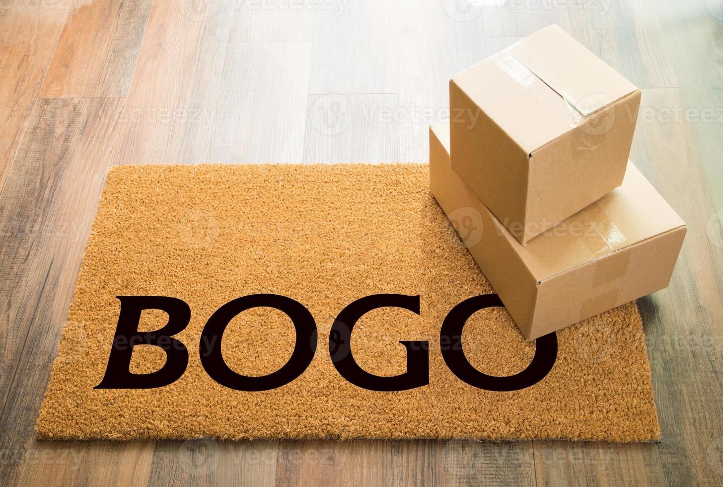 BOGO Welcome Mat On Wood Floor With Shipment of Boxes photo