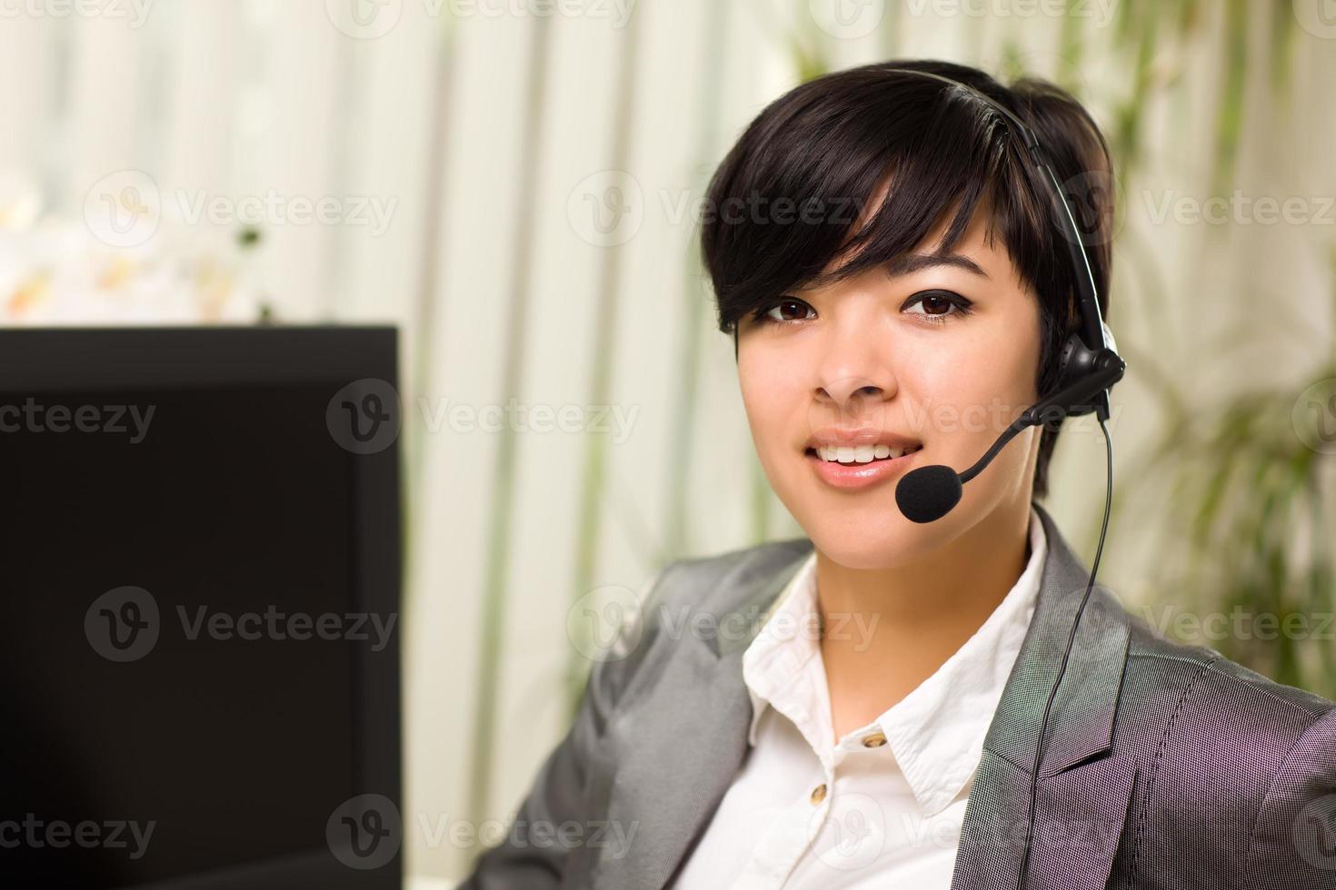 Attractive Young Woman Smiles Wearing Headset photo