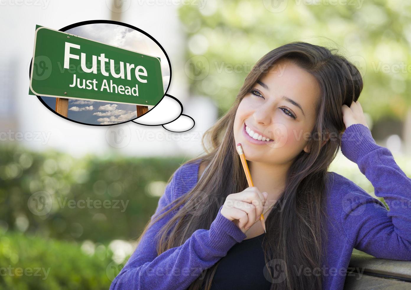 Young Woman with Thought Bubble of Future Green Road Sign photo