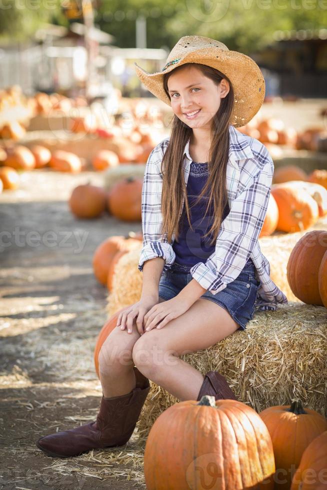 retrato de niña preadolescente en el huerto de calabazas foto