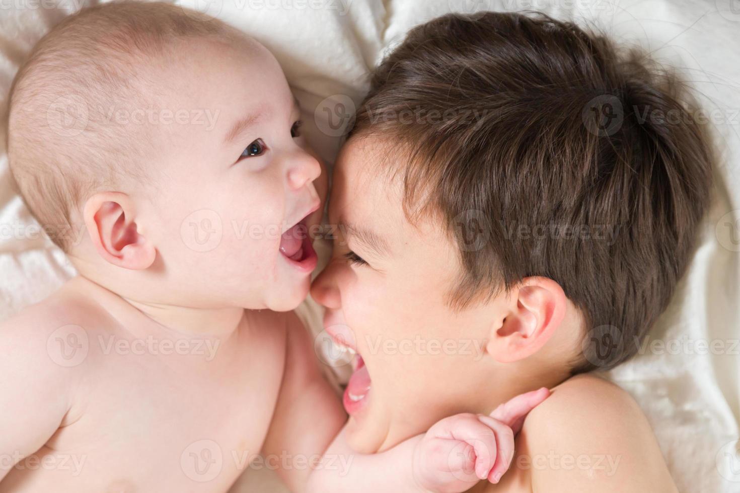 Mixed Race Chinese and Caucasian Baby Brothers Having Fun Laying on Their Blanket photo