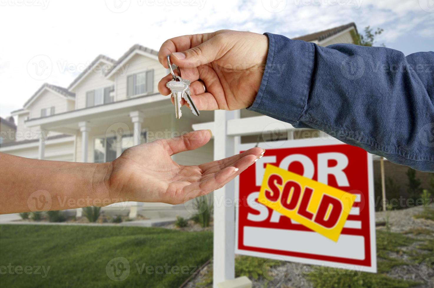 Handing Over the House Keys in Front of New Home photo