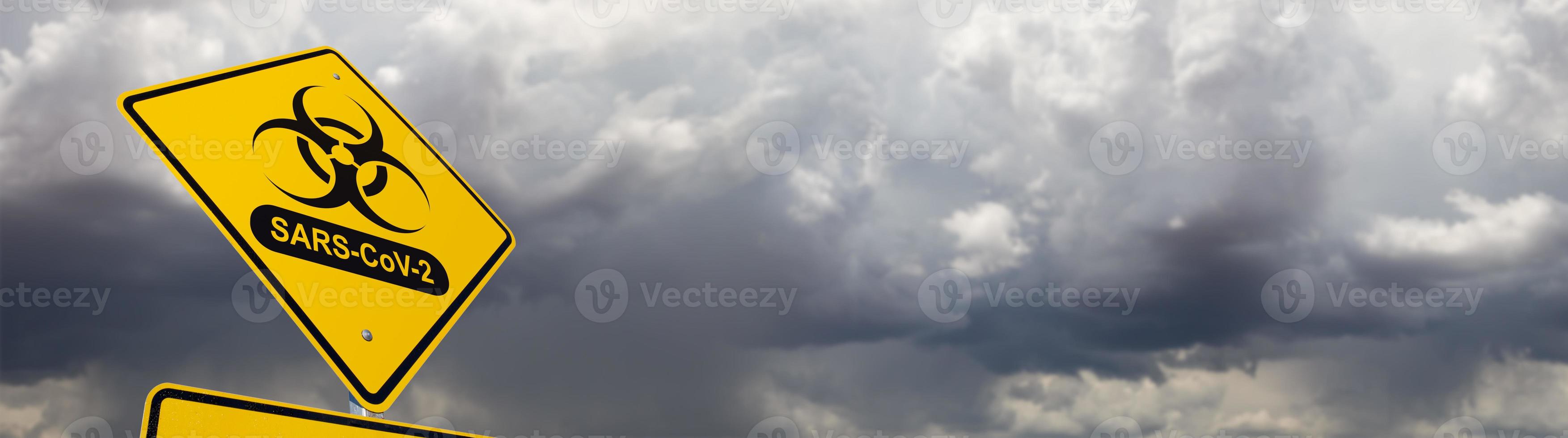 Bio-hazard Symbol With SARS-CoV-2 Coronaravirus Yellow Road Sign Against Ominous Stormy Cloudy Sky Banner photo