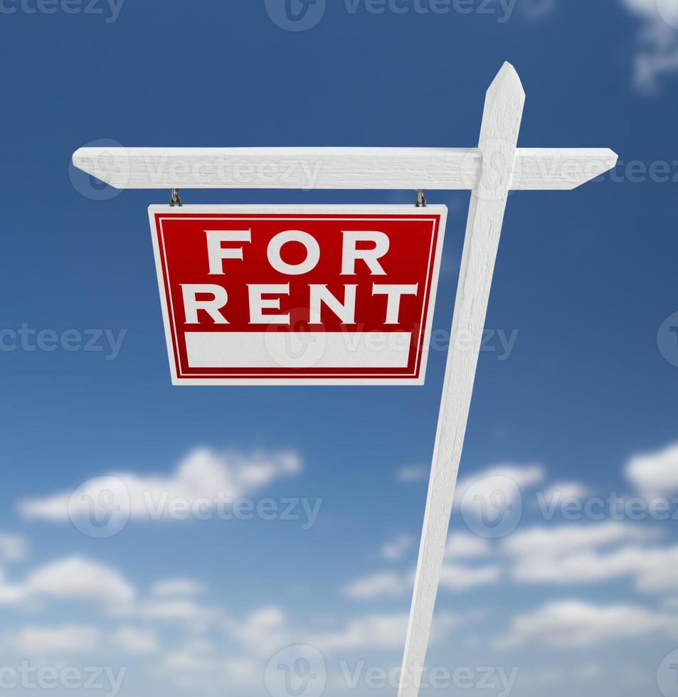 Left Facing For Rent Real Estate Sign on a Blue Sky with Clouds. photo