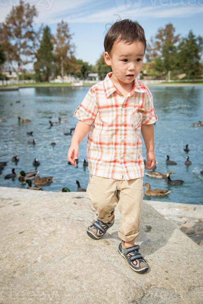 Young Chinese and Caucasian Boy Having Fun at the Park and Duck Pond. photo
