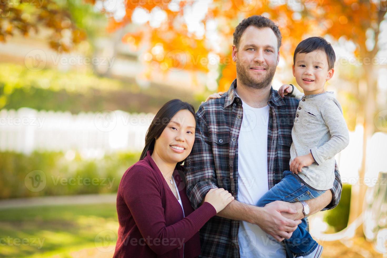 Outdoor Portrait of Mixed Race Chinese and Caucasian Parents and Child. photo