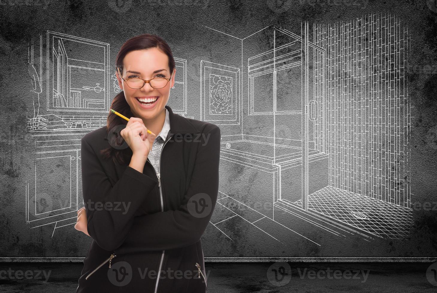 Young Adult Woman with Pencil In Front of Bathroom Design Drawing On Wall photo