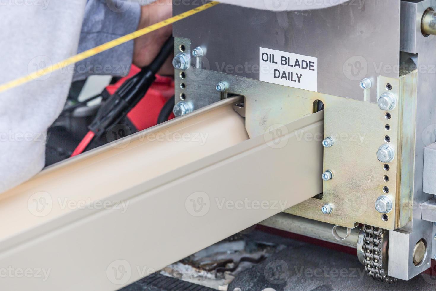 Worker Measuring Rain Gutter Processing Through Seamless Shaping Machine photo
