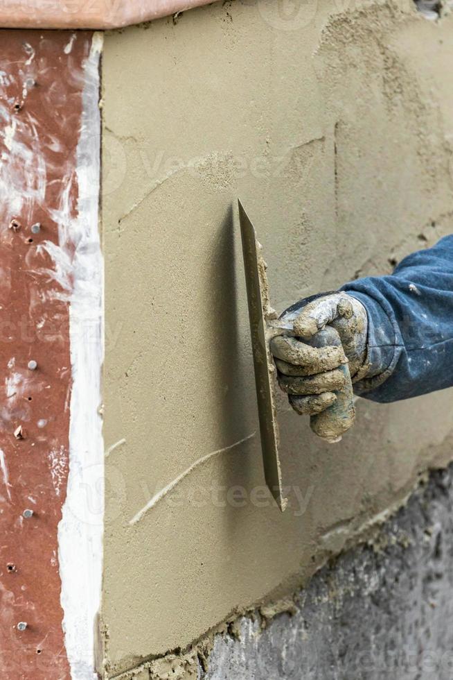 Tile Worker Applying Cement with Trowel at Pool Construction Site photo