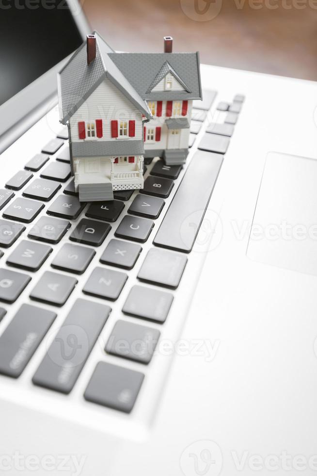 Miniature House on Laptop Computer photo