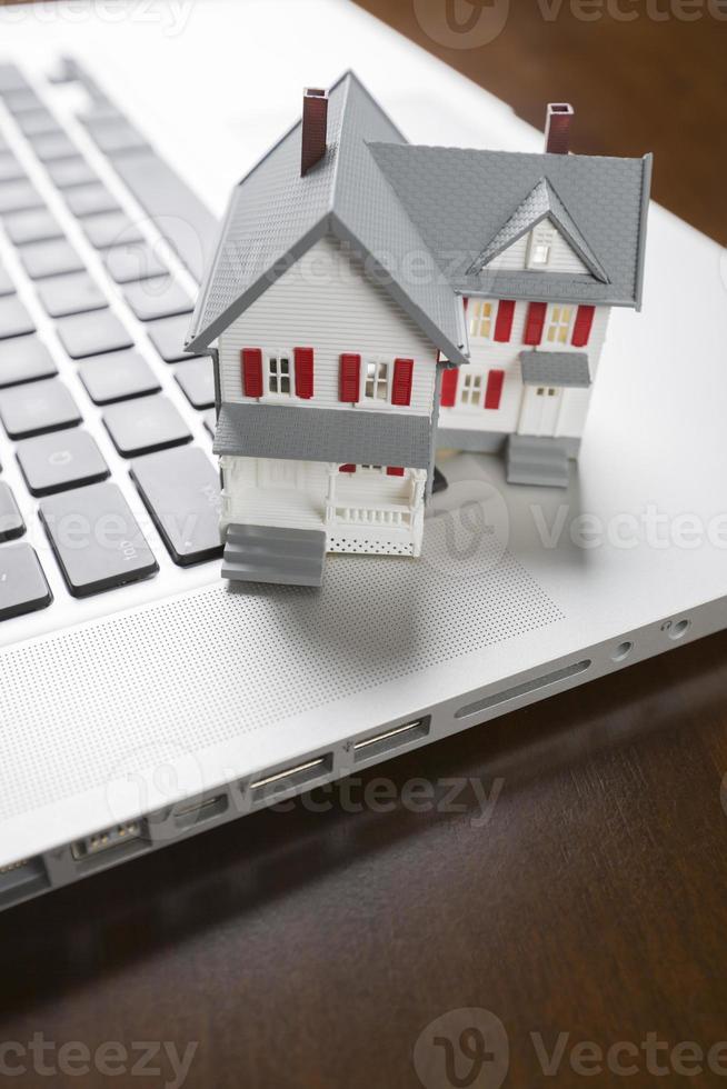 Miniature House on Laptop Computer photo