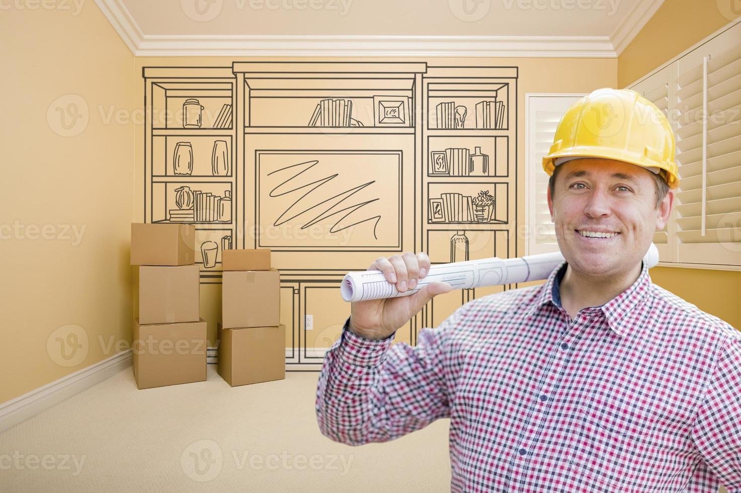 Male Construction Worker In Room With Drawing of Entertainment Unit photo