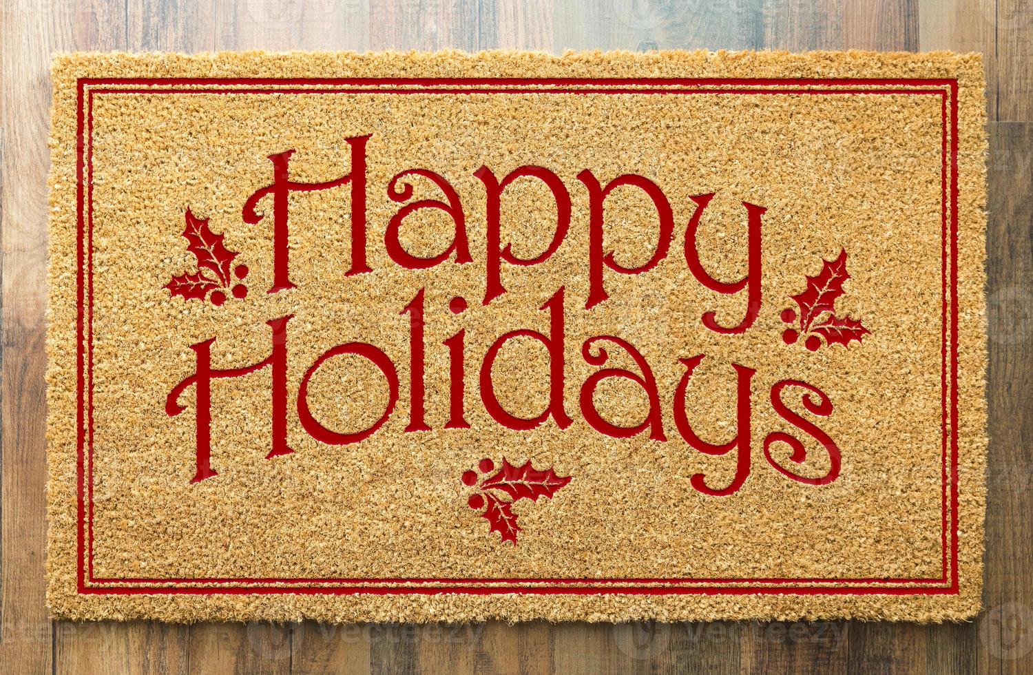 Happy Holidays Christmas Tad Welcome Mat On Wood Floor Background photo