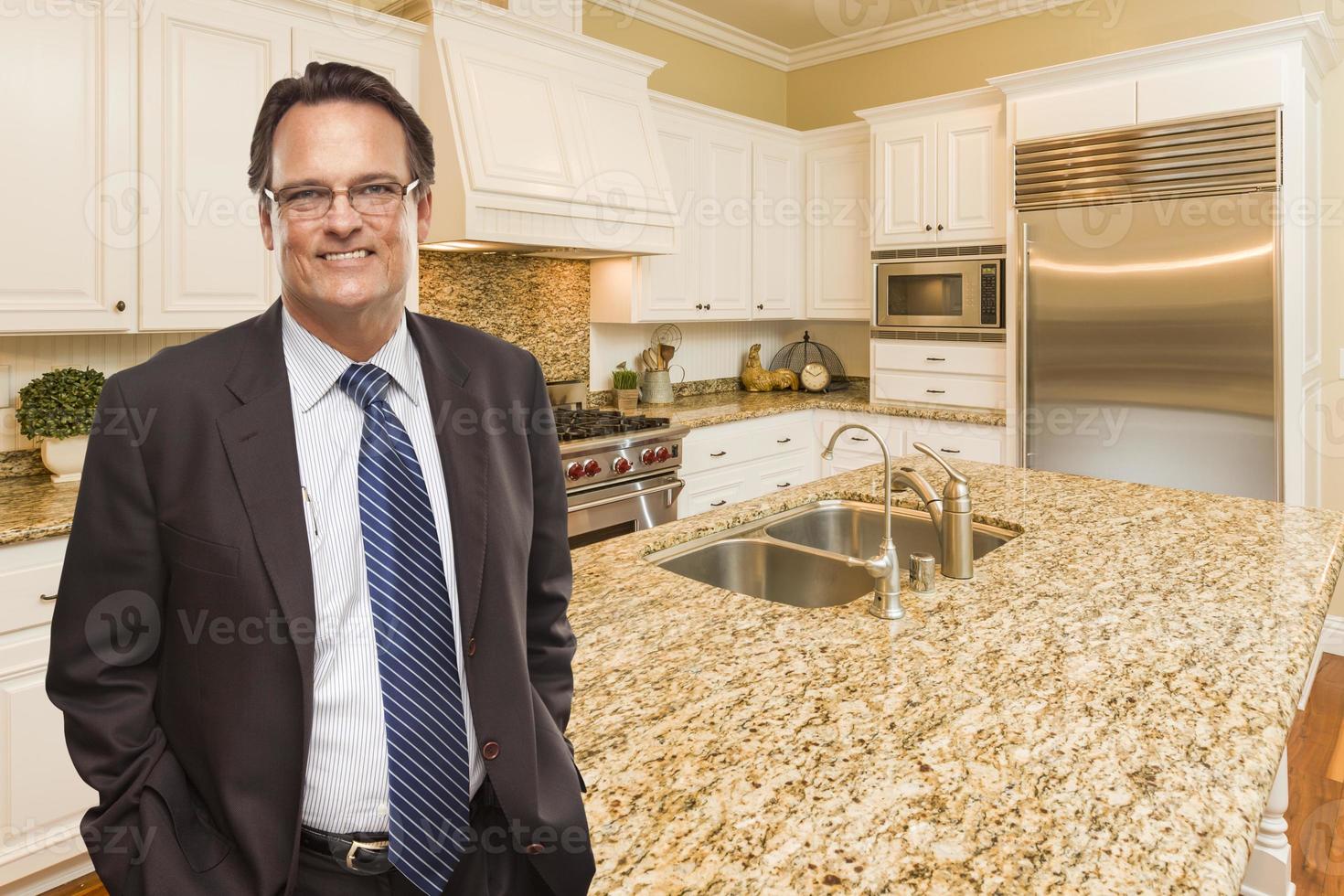 Man Wearing Necktie in Beautiful Custom Residential Kitchen photo