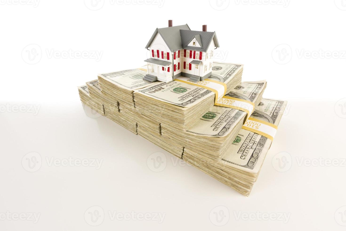 Small House on Stacks of Hundred Dollar Bills photo