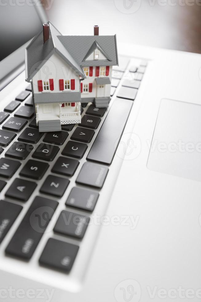 Miniature House on Laptop Computer photo