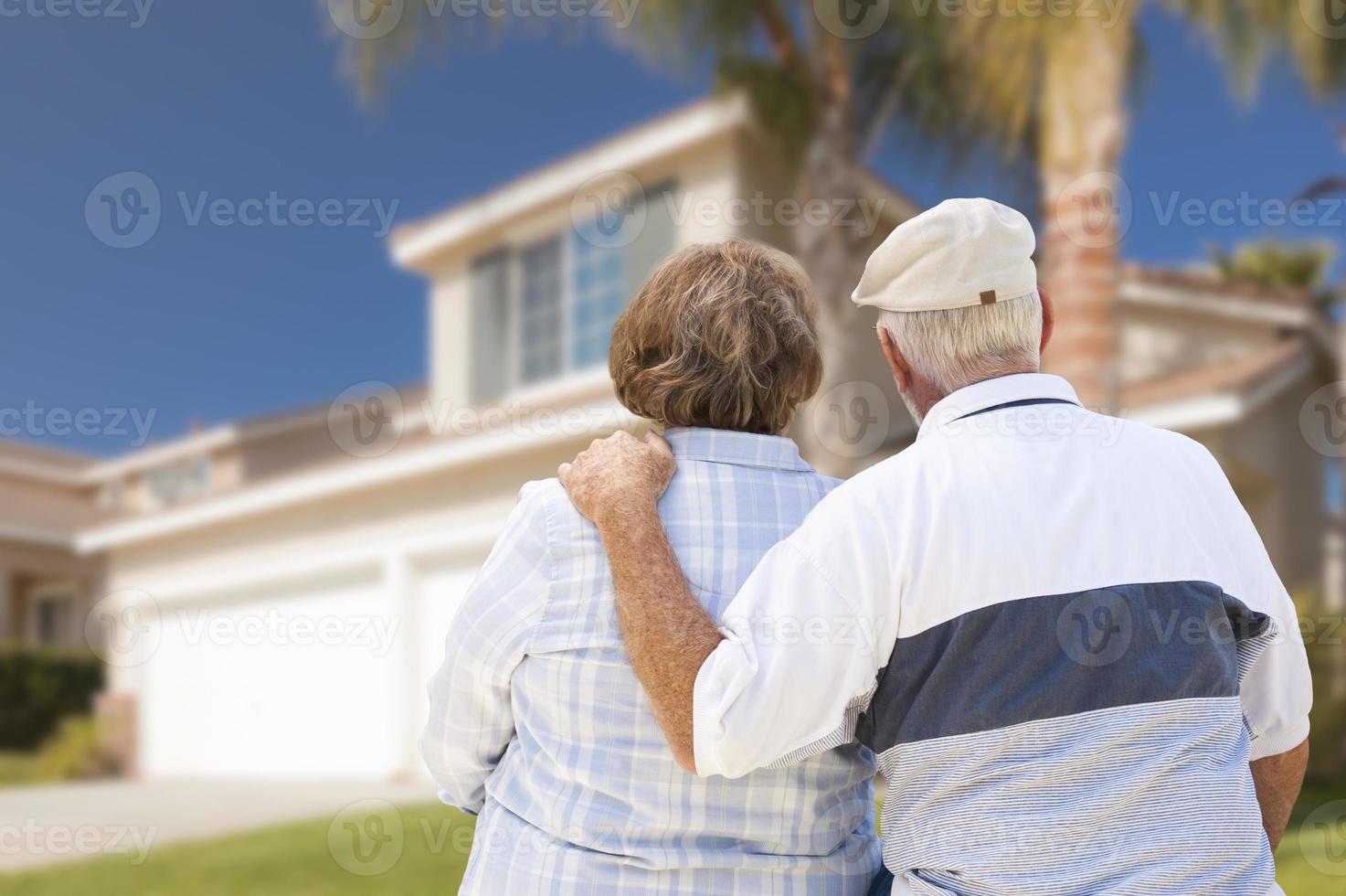 Happy Senior Couple Looking at Front of House photo