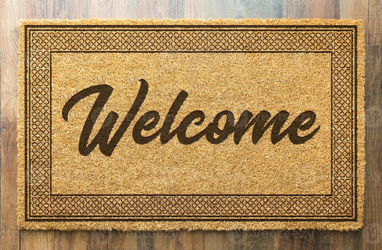 Welcome Mat On A Wood Floor Background photo