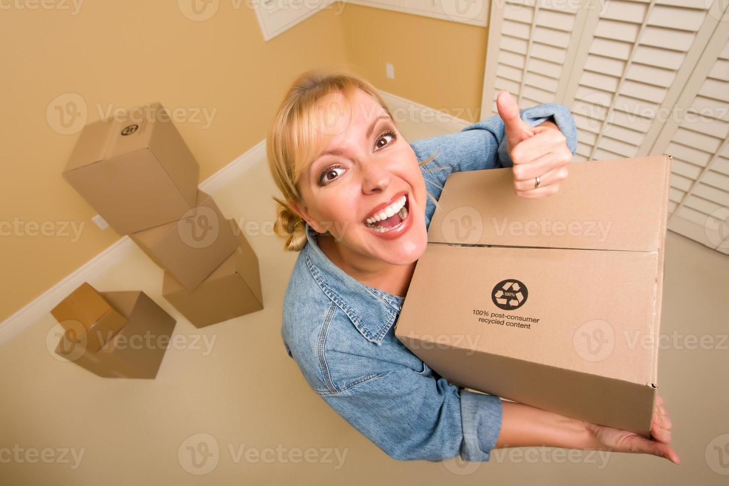 Happy Thumbs Up Woman Moving Boxes photo