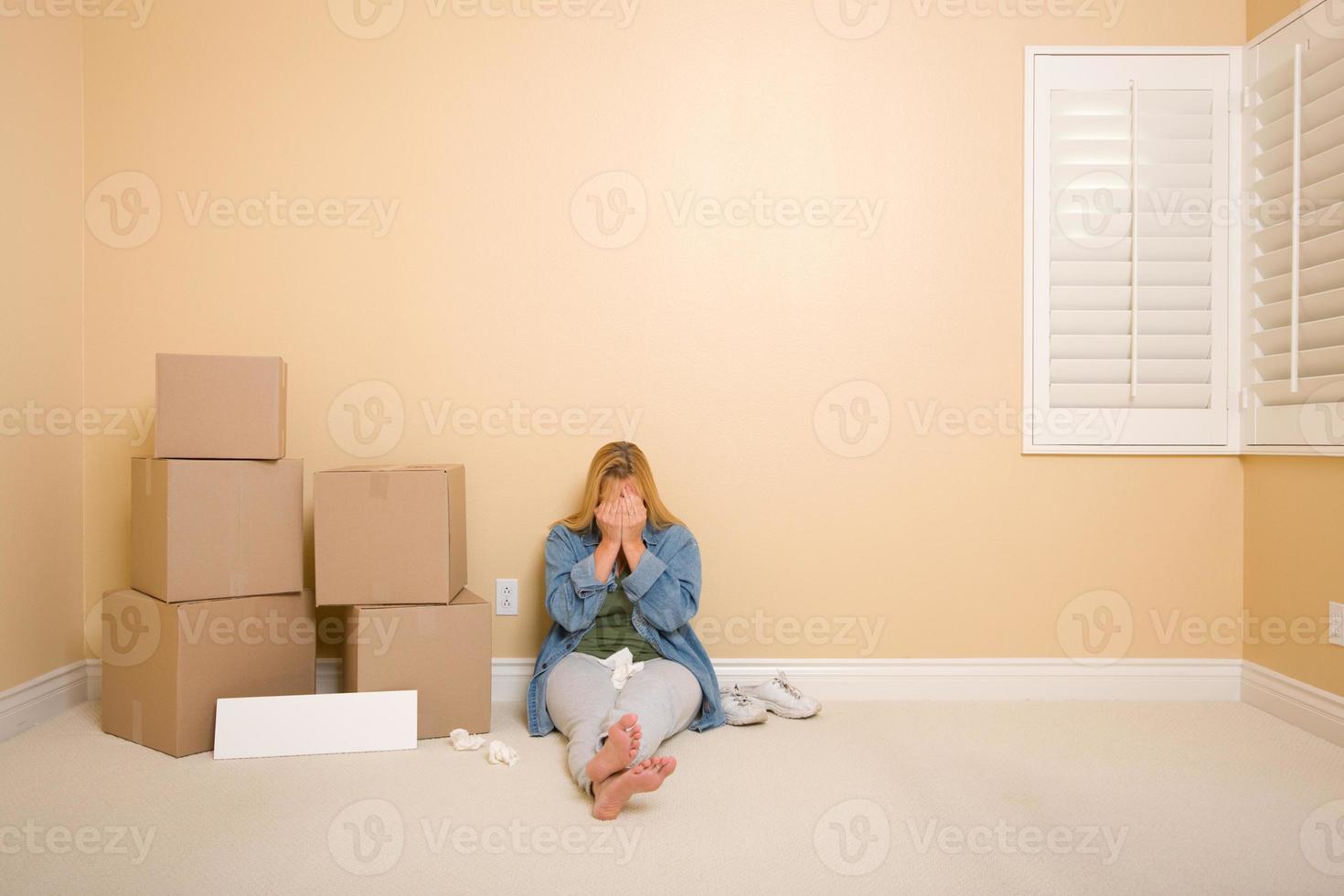 Upset Woman on Floor Next to Boxes and Blank Sign photo