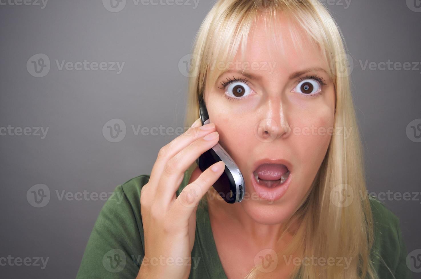 Stunned Blond Woman Using Cell Phone photo