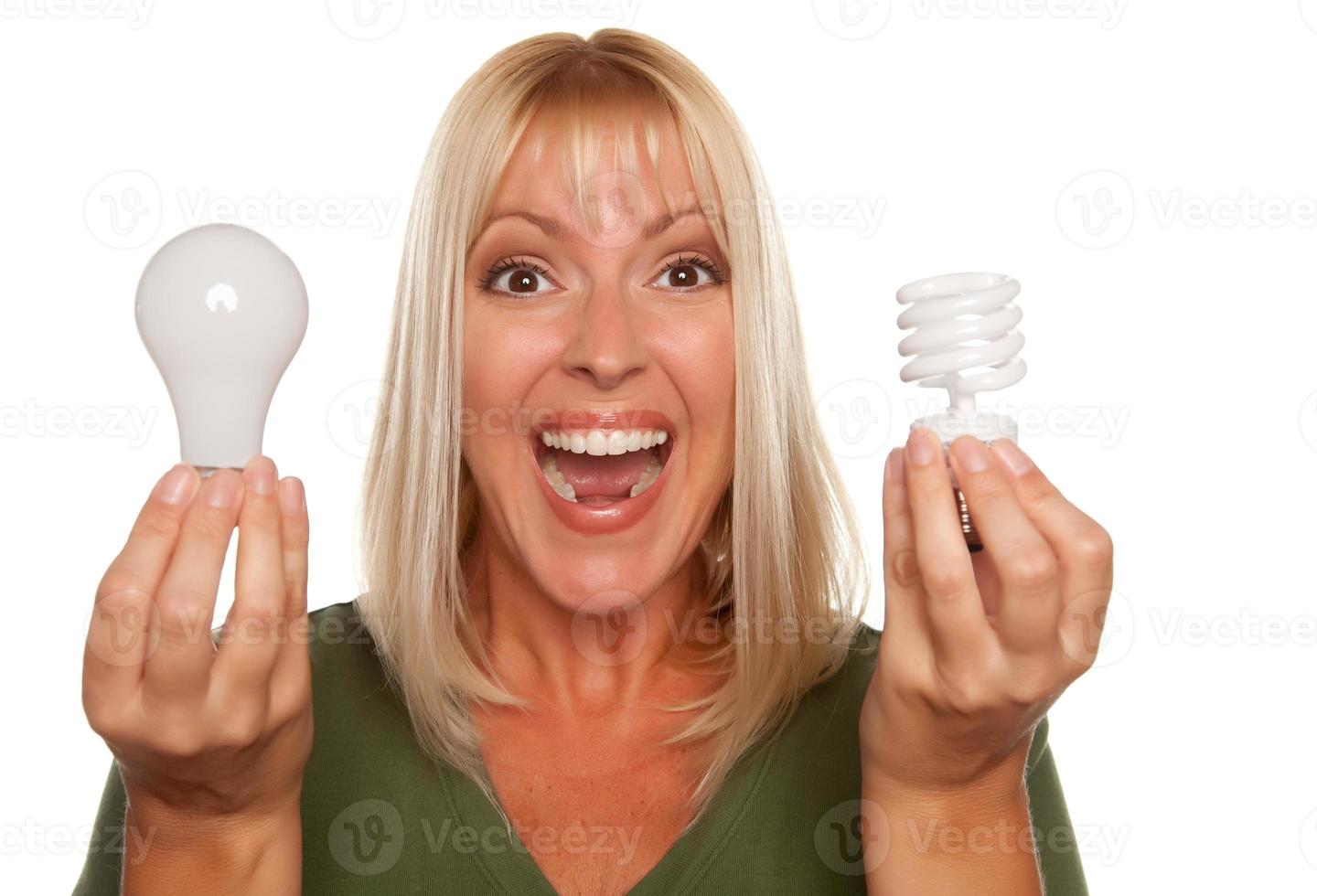 Woman Holds Energy Saving and Regular Light Bulbs photo