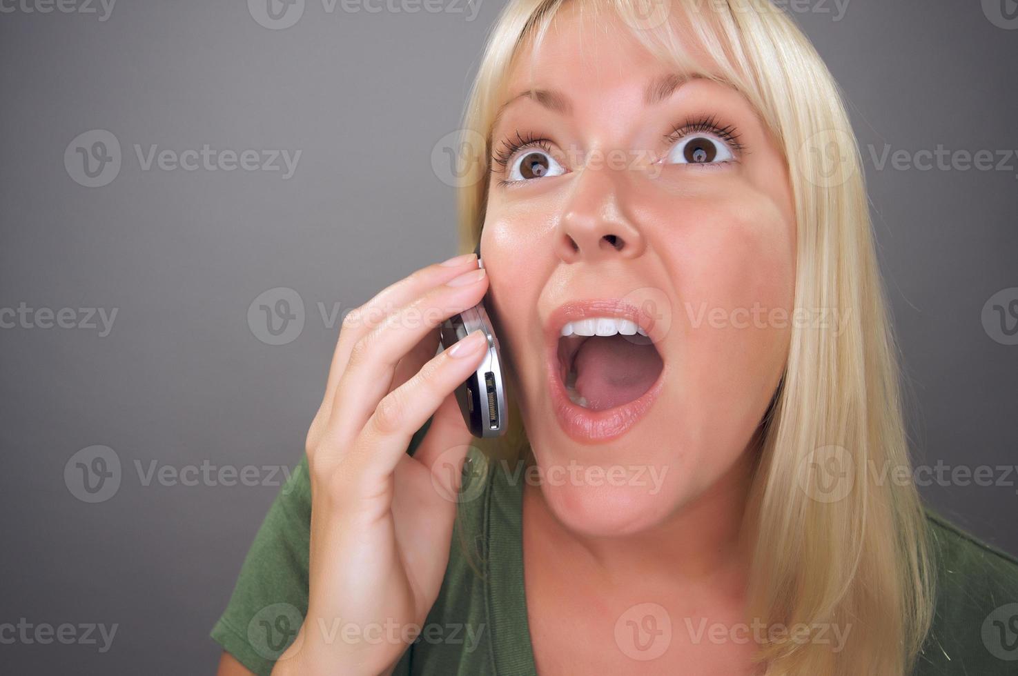 Stunned Blond Woman Using Cell Phone photo