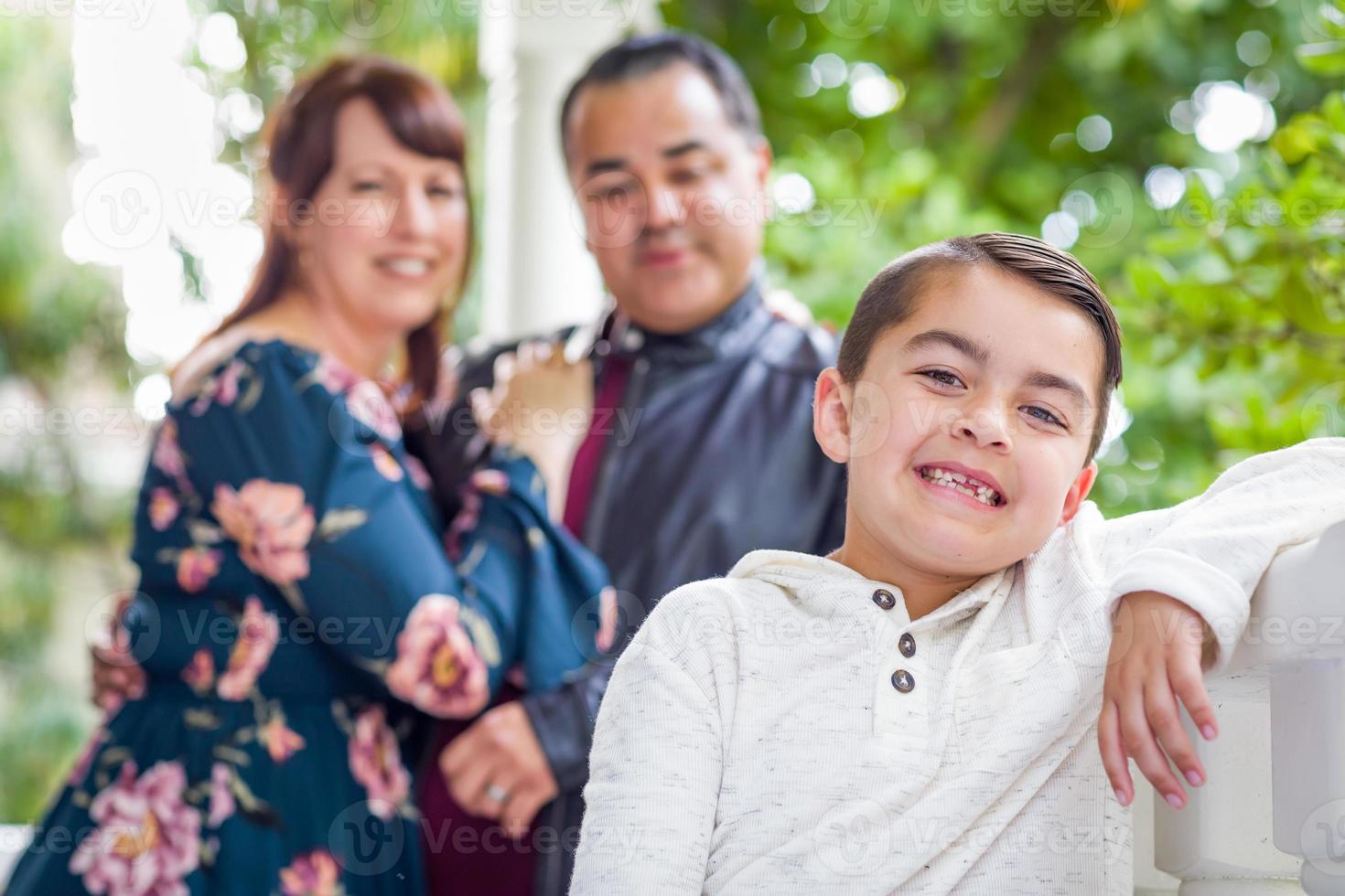 Portrait of Mixed Race Couple Standing Behind Young Son photo