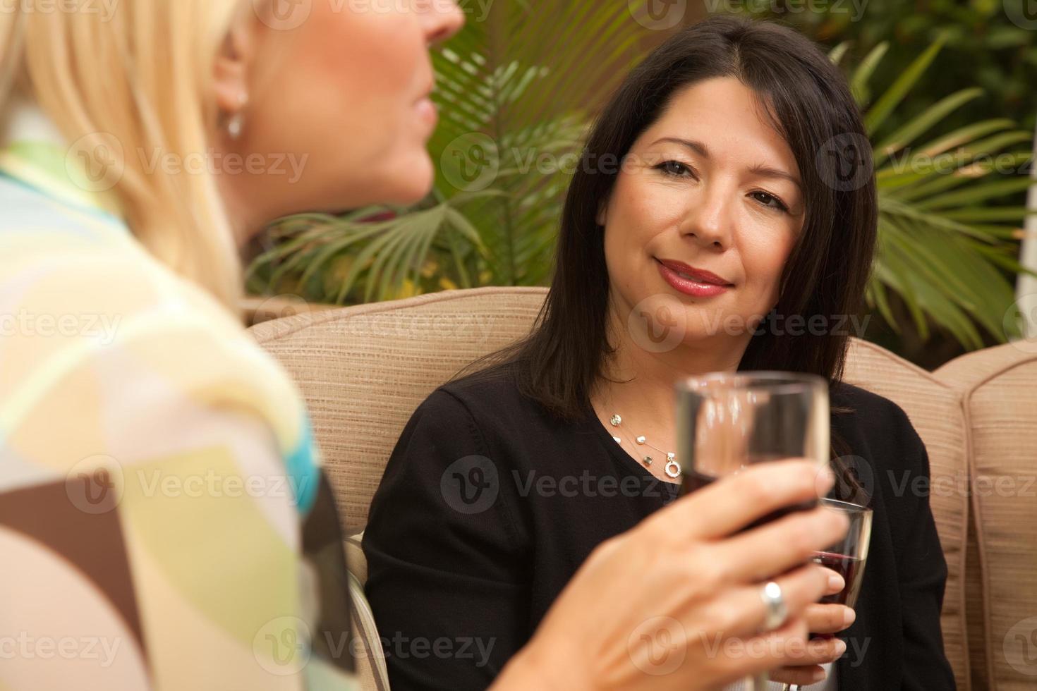 Two Girlfriends Enjoy Wine on the Patio photo