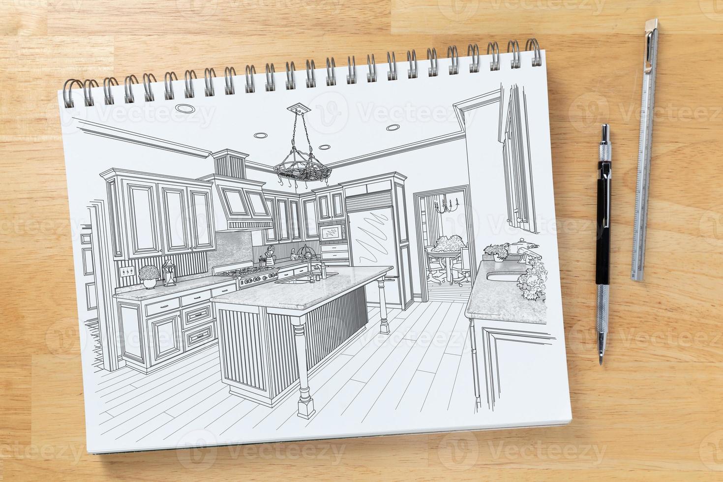Sketch Pad on Desk Top with Drawing of Custom Kitchen Interior Next To Engineering Pencil and Ruler Scale photo