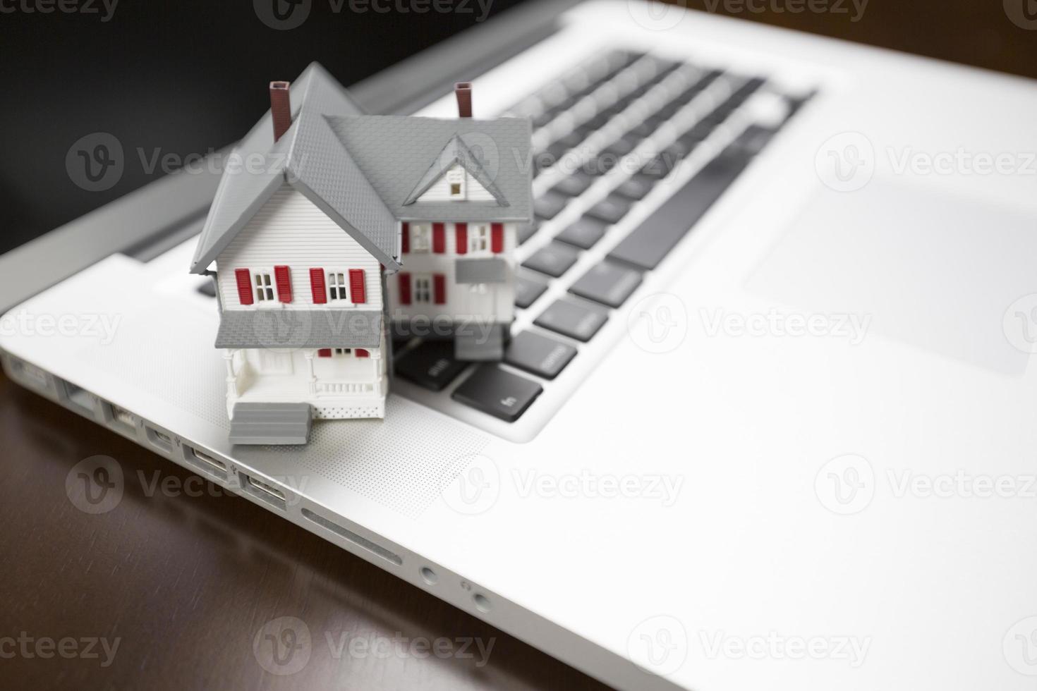 Miniature House on Laptop Computer photo
